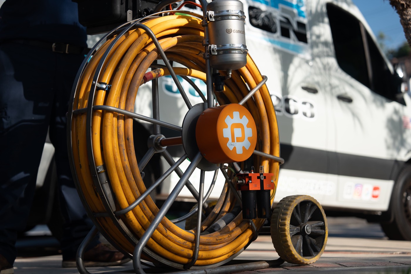 Robotic cutter reel next to a Rooter Champion van